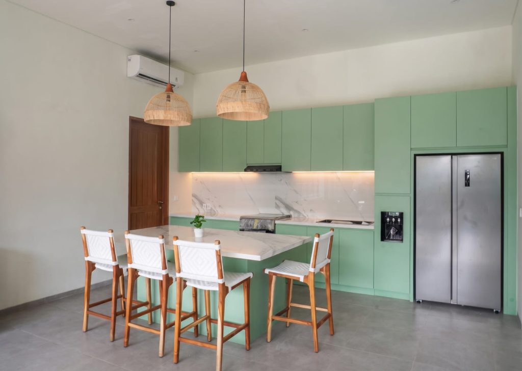 Bali Interio custom hybrid kitchen island featuring a pull-out teak dining table extension in a modern tropical villa