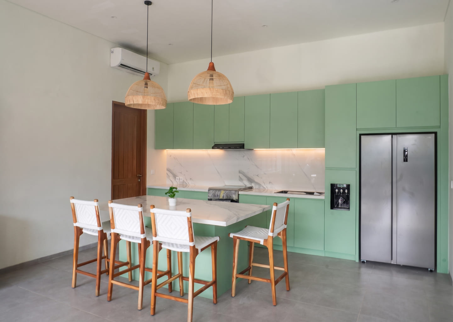 Bali Interio custom hybrid kitchen island featuring a pull-out teak dining table extension in a modern tropical villa
