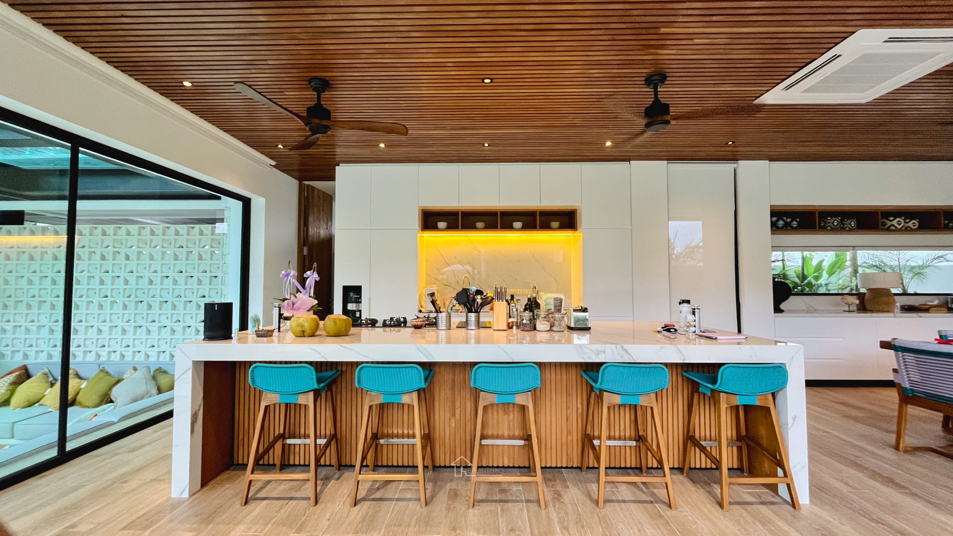 Custom kitchen set bali featuring handleless wood wall cabinetry, integrated LED lighting, and built-in appliances by Bali Interio